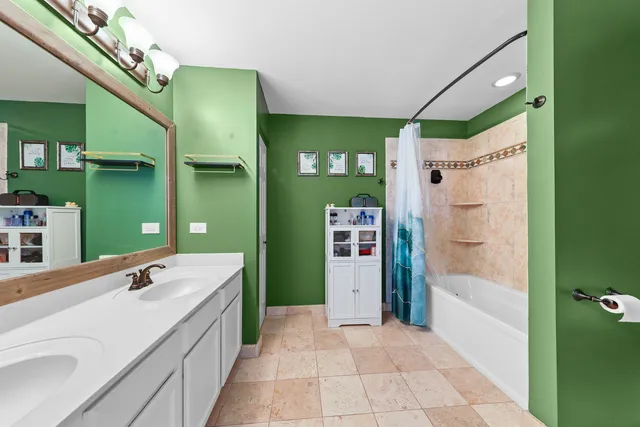 a spacious bathroom with a double vanity sink and a mirror