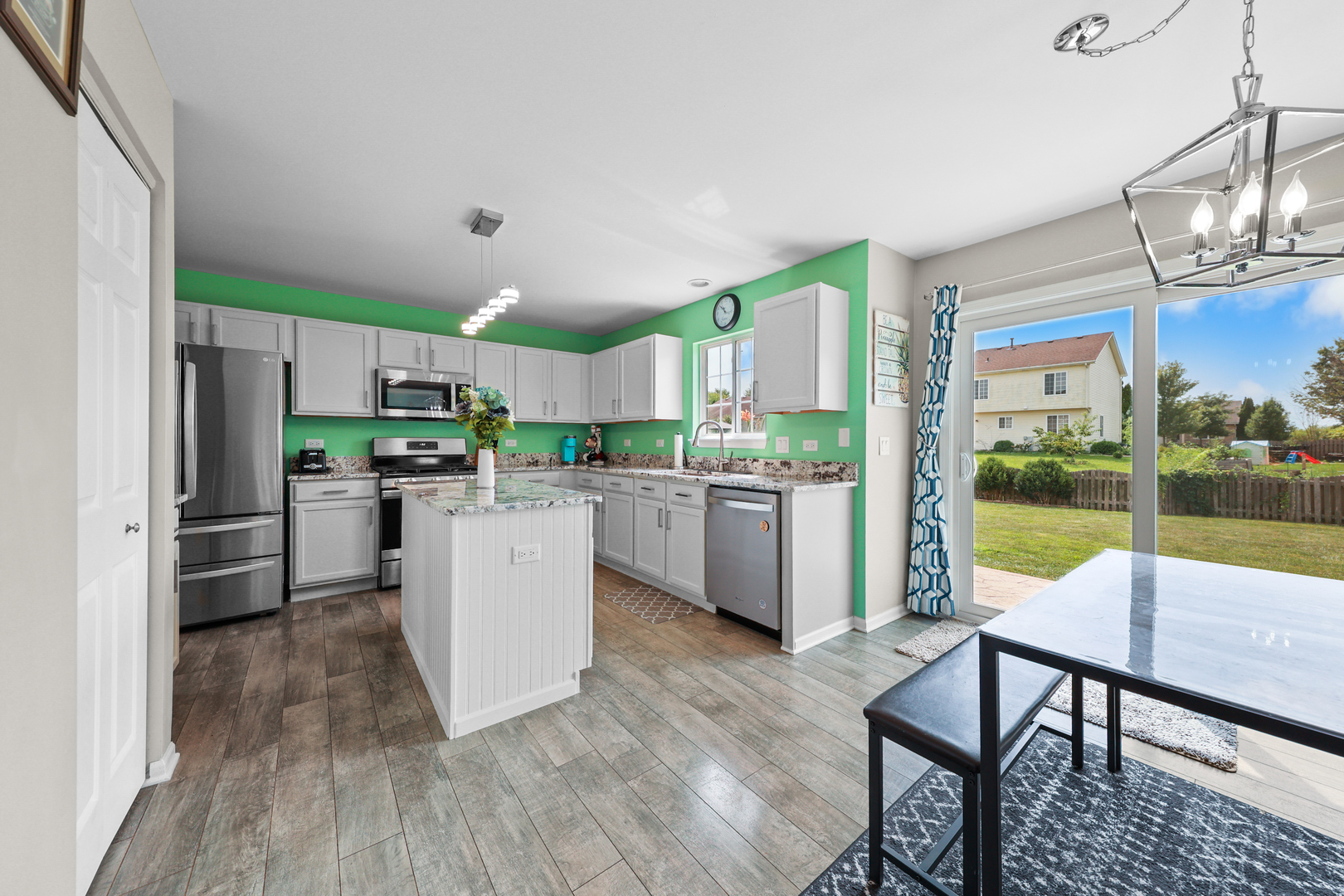 1468 Sedge Pass Minooka, IL 60447 - Photo 2 of 19 a kitchen with a table chairs refrigerator and cabinets