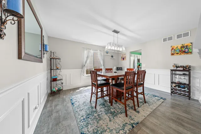 a view of a dining room with furniture and wooden floor