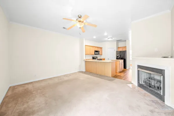 a view of a kitchen with a sink and a refrigerator