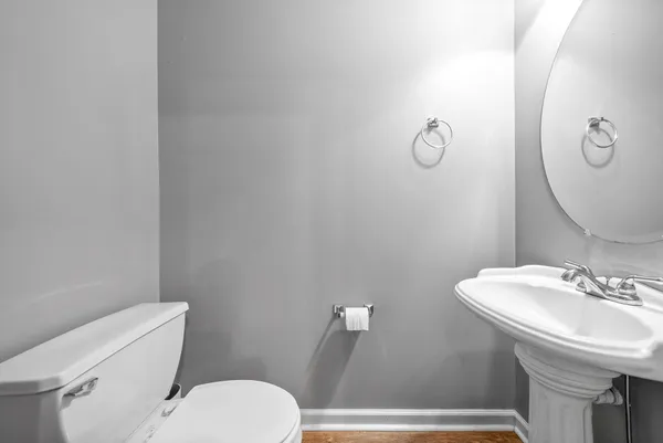 a white toilet sitting next to a bathroom sink