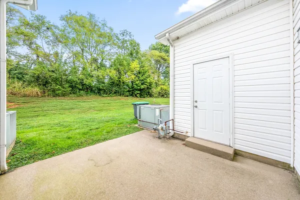 a view of a chair and fire pit in the backyard