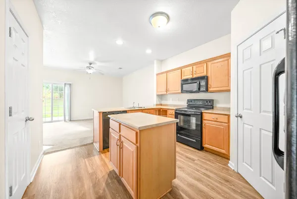 a kitchen with a stove top oven and refrigerator