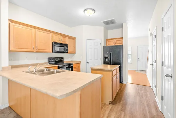 a kitchen with stainless steel appliances a stove refrigerator sink and cabinets