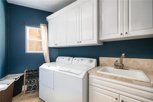 a living room with furniture a table and a large window