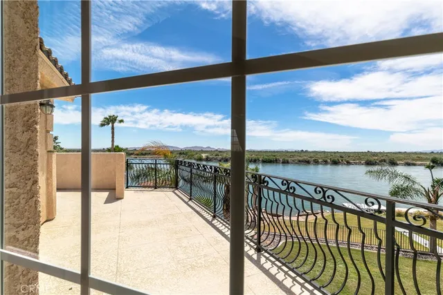 a dining room with furniture and a floor to ceiling window