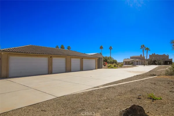 a view of hallway with wooden floor and bathroom
