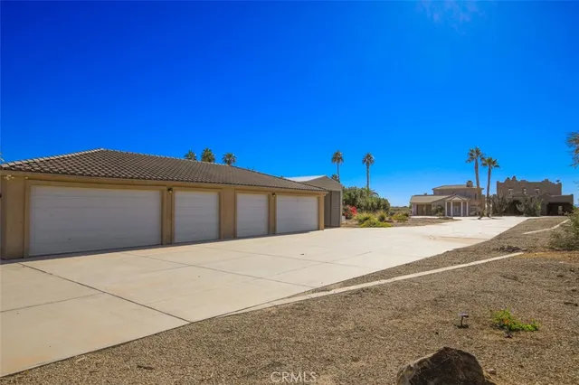 a view of hallway with wooden floor and bathroom