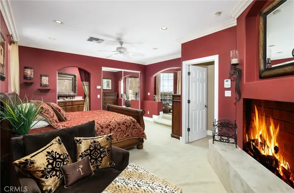 a bed sitting in a spacious bedroom next to a window