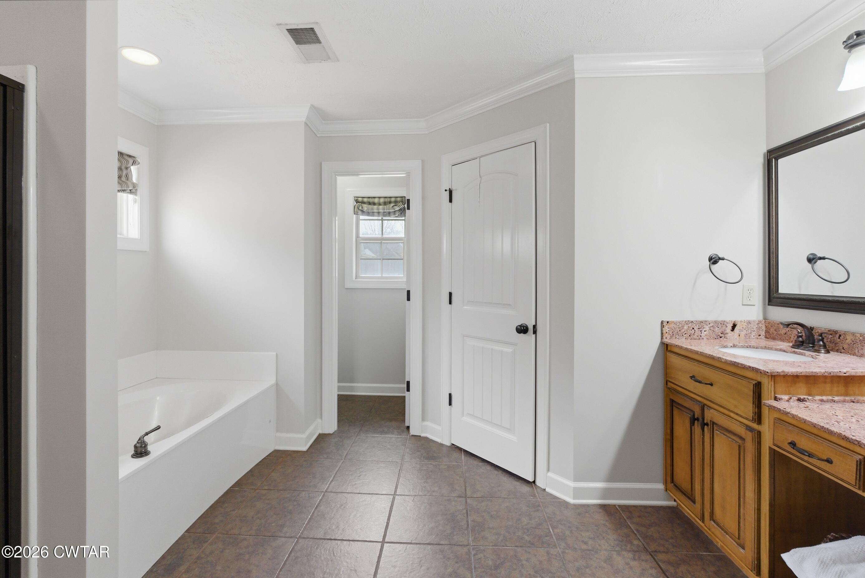 325 Harvest Ridge Lane Medina, TN 38355 - Photo 30 of 43 a bathroom with a tub sink vanity and mirror