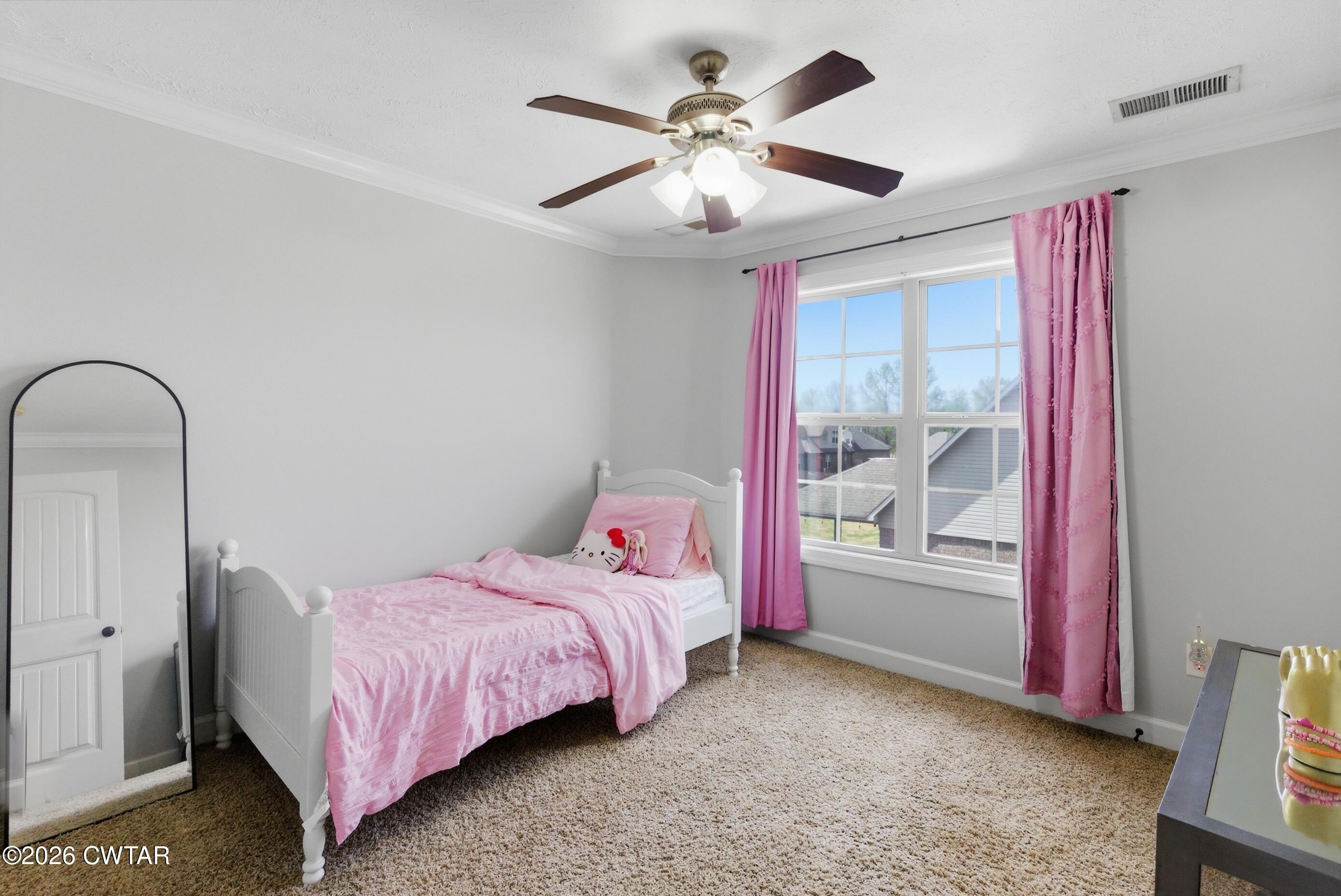 325 Harvest Ridge Lane Medina, TN 38355 - Photo 31 of 43 a bedroom with a bed and a chandelier