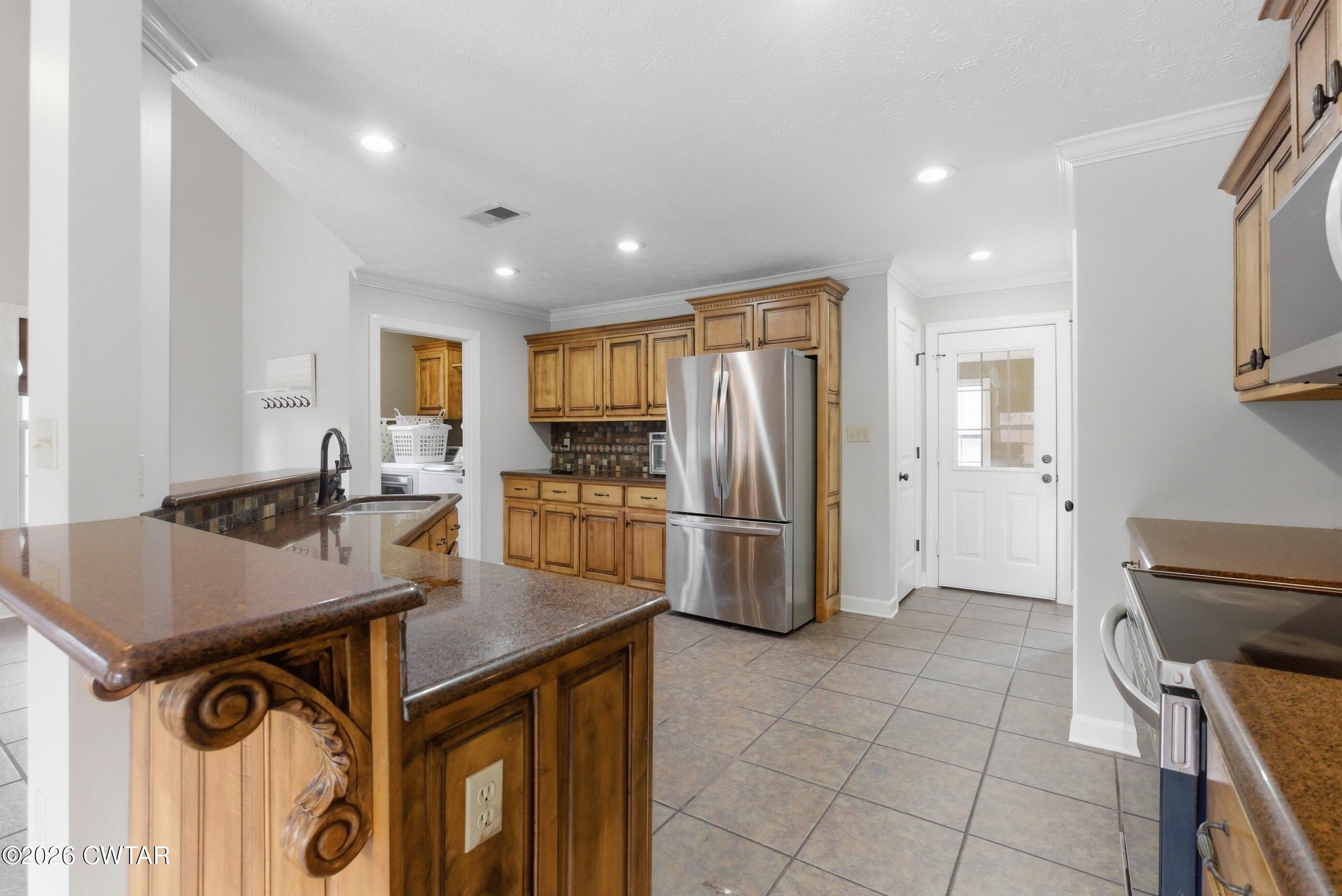 325 Harvest Ridge Lane Medina, TN 38355 - Photo 6 of 43 a kitchen with a refrigerator a stove a sink and a counter top space