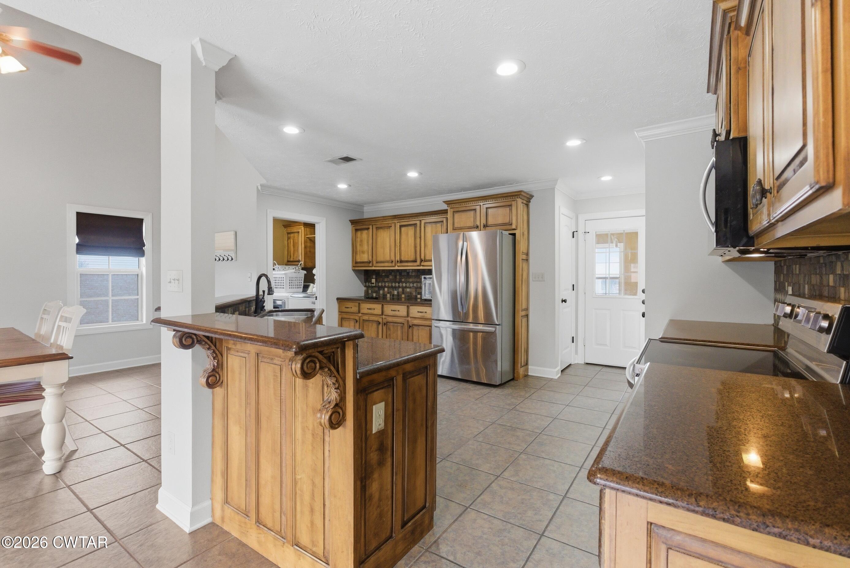 325 Harvest Ridge Lane Medina, TN 38355 - Photo 7 of 43 a kitchen with stainless steel appliances granite countertop a sink a stove a refrigerator and a cabinets