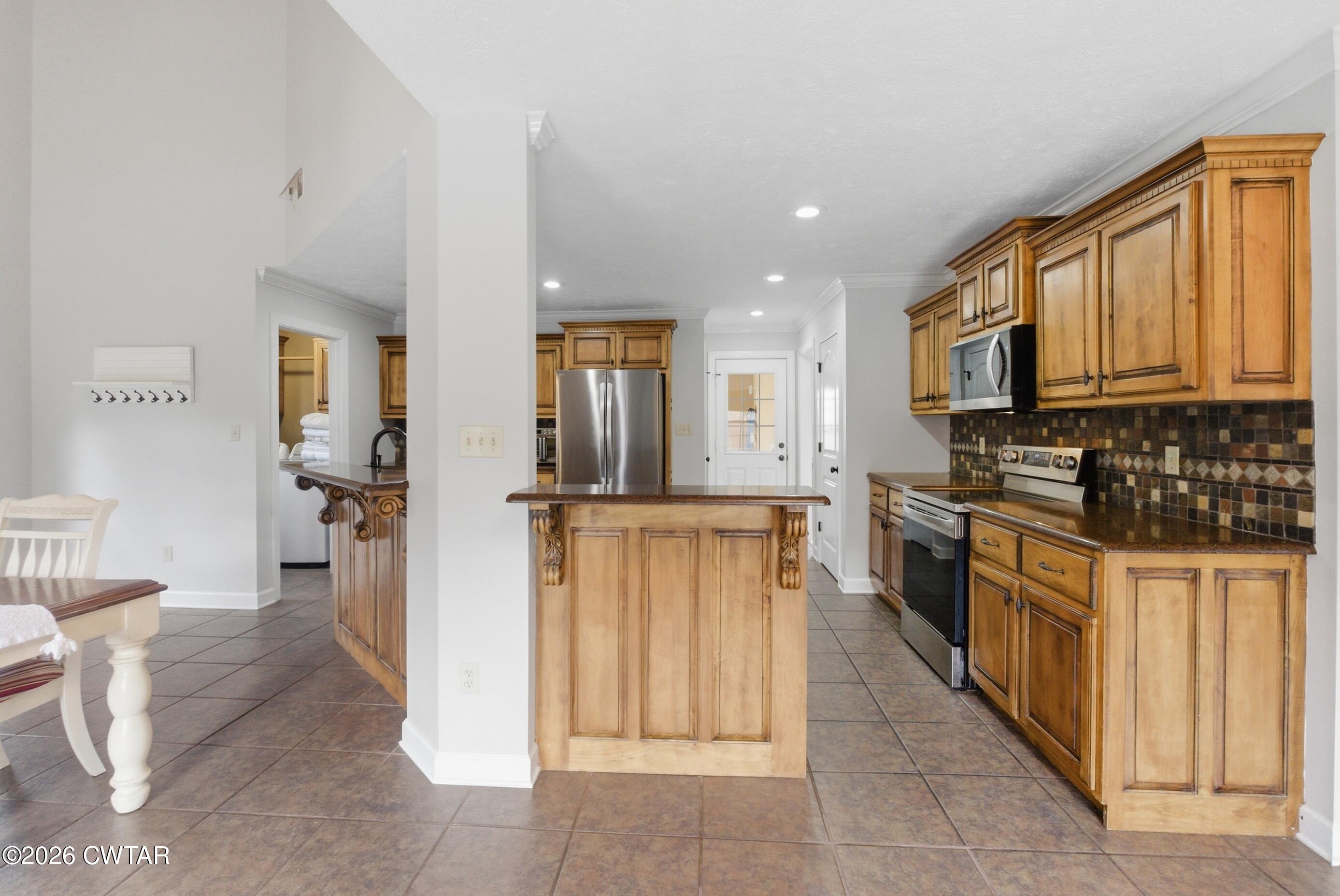 325 Harvest Ridge Lane Medina, TN 38355 - Photo 10 of 43 a kitchen with stainless steel appliances granite countertop a refrigerator oven a sink dishwasher and white cabinets with wooden floor