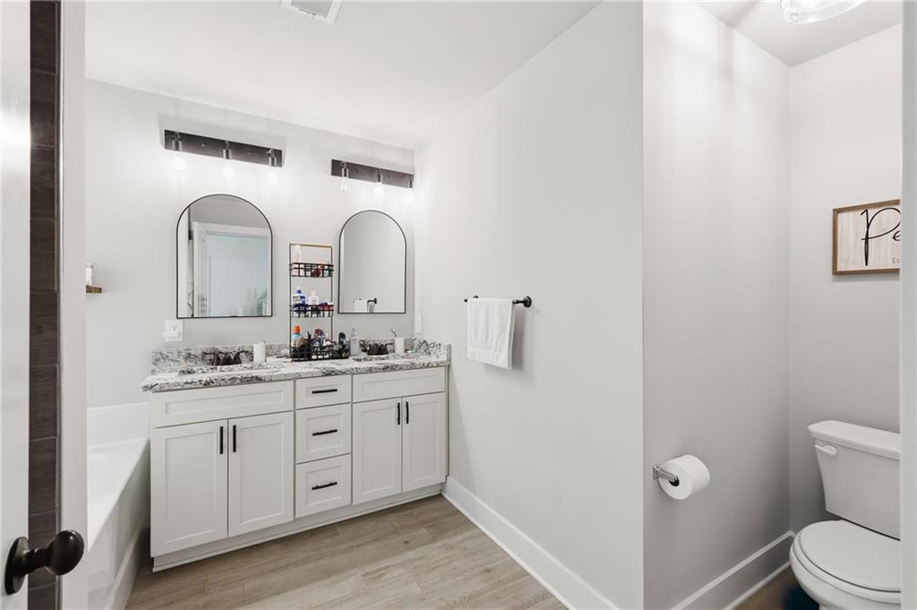 164 Mary Saphire Road Dawsonville, GA 30534 - Photo 15 of 25 a bathroom with a double vanity sink and a toilet
