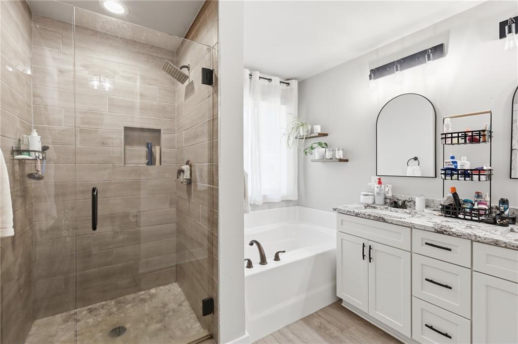 164 Mary Saphire Road Dawsonville, GA 30534 - Photo 16 of 25 a bathroom with a tub sink toilet and a mirror