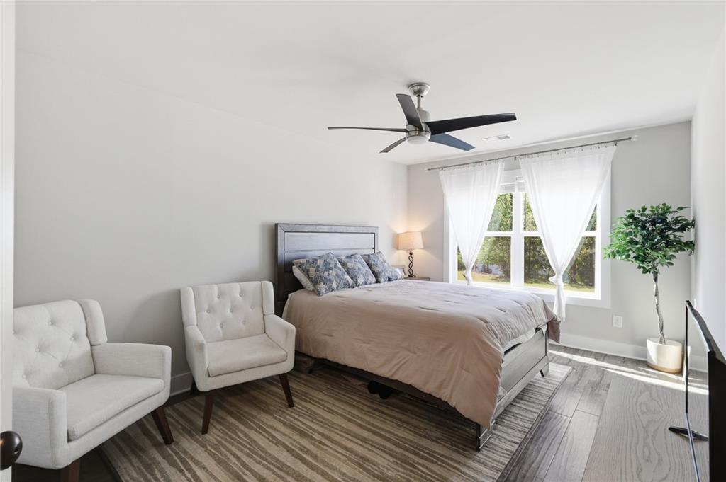 164 Mary Saphire Road Dawsonville, GA 30534 - Photo 17 of 25 a bedroom with a bed couch and a potted plant