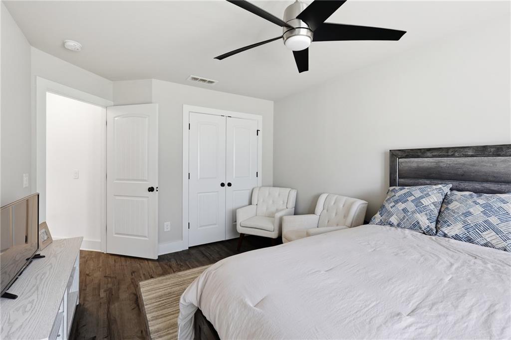 164 Mary Saphire Road Dawsonville, GA 30534 - Photo 18 of 25 a bedroom with bed and a chandelier