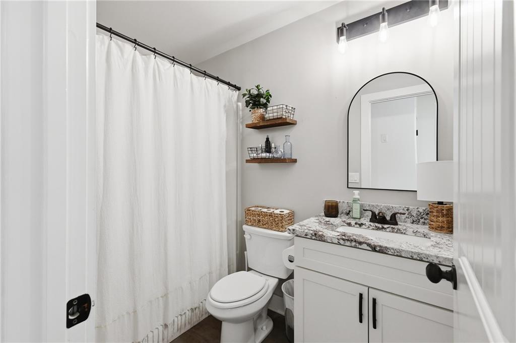 164 Mary Saphire Road Dawsonville, GA 30534 - Photo 20 of 25 a bathroom with a granite countertop sink and a mirror