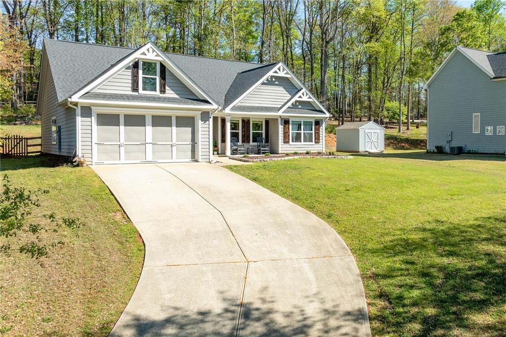 164 Mary Saphire Road Dawsonville, GA 30534 - Photo 2 of 25 a front view of a house with a garden