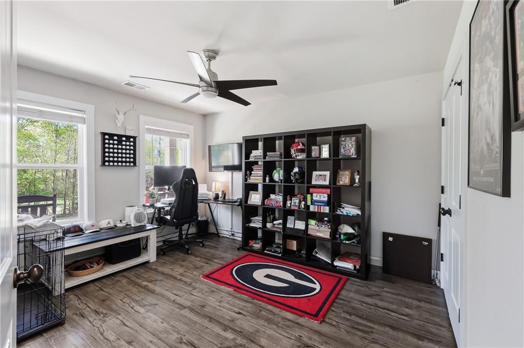 164 Mary Saphire Road Dawsonville, GA 30534 - Photo 21 of 25 a living room with furniture a rug and bookshelf