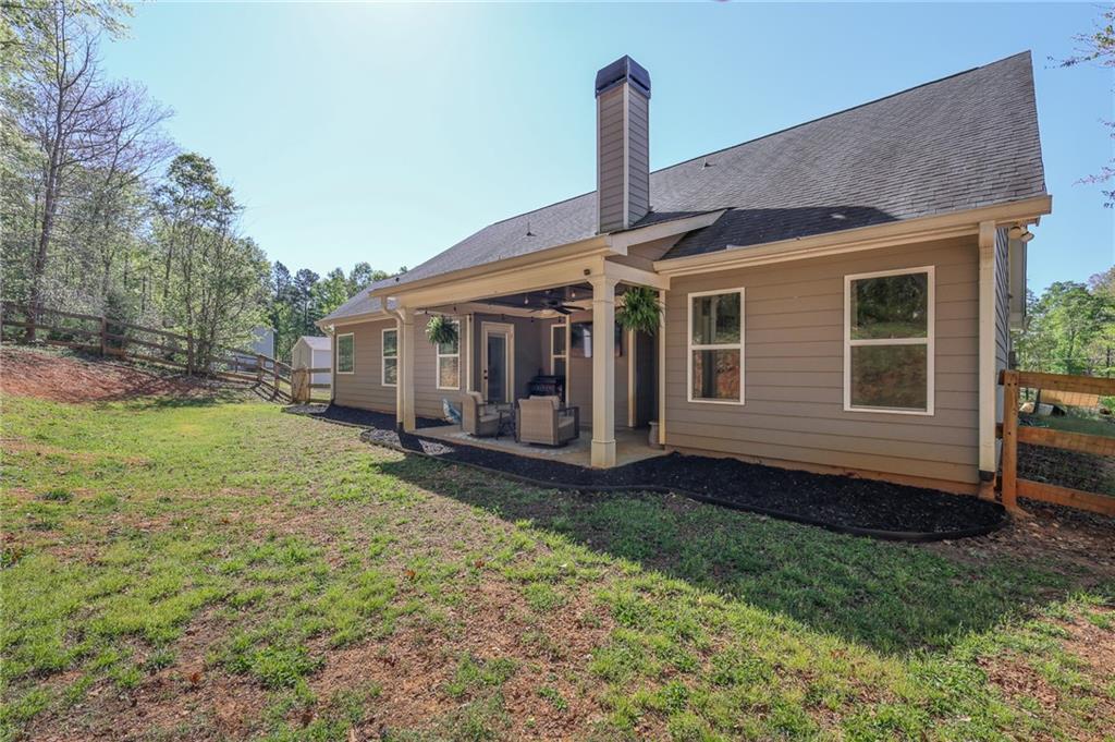 164 Mary Saphire Road Dawsonville, GA 30534 - Photo 22 of 25 a view of a house with backyard and a tree