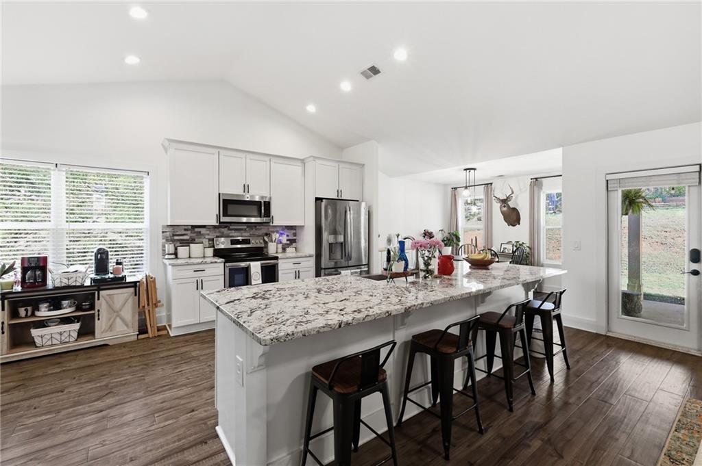 164 Mary Saphire Road Dawsonville, GA 30534 - Photo 5 of 25 a kitchen with stainless steel appliances granite countertop a kitchen island hardwood floor and a sink