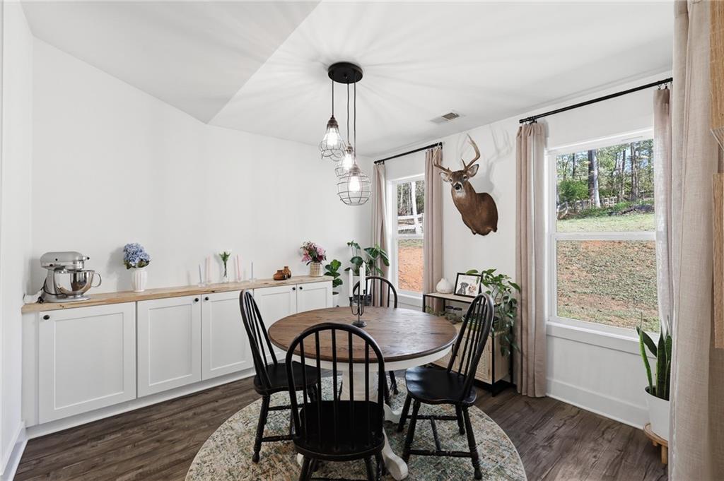 164 Mary Saphire Road Dawsonville, GA 30534 - Photo 9 of 25 a view of a dining room with furniture window and wooden floor