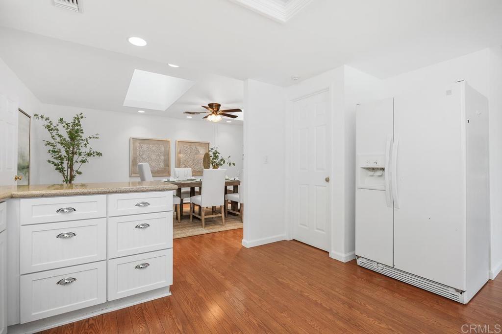 1277 Cypress Drive Vista, CA 92084 - Photo 15 of 18 a view of a hallway with wooden floor windows and cabinet