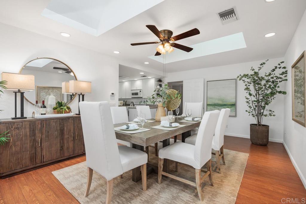 1277 Cypress Drive Vista, CA 92084 - Photo 16 of 18 a view of a dining room with furniture and wooden floor