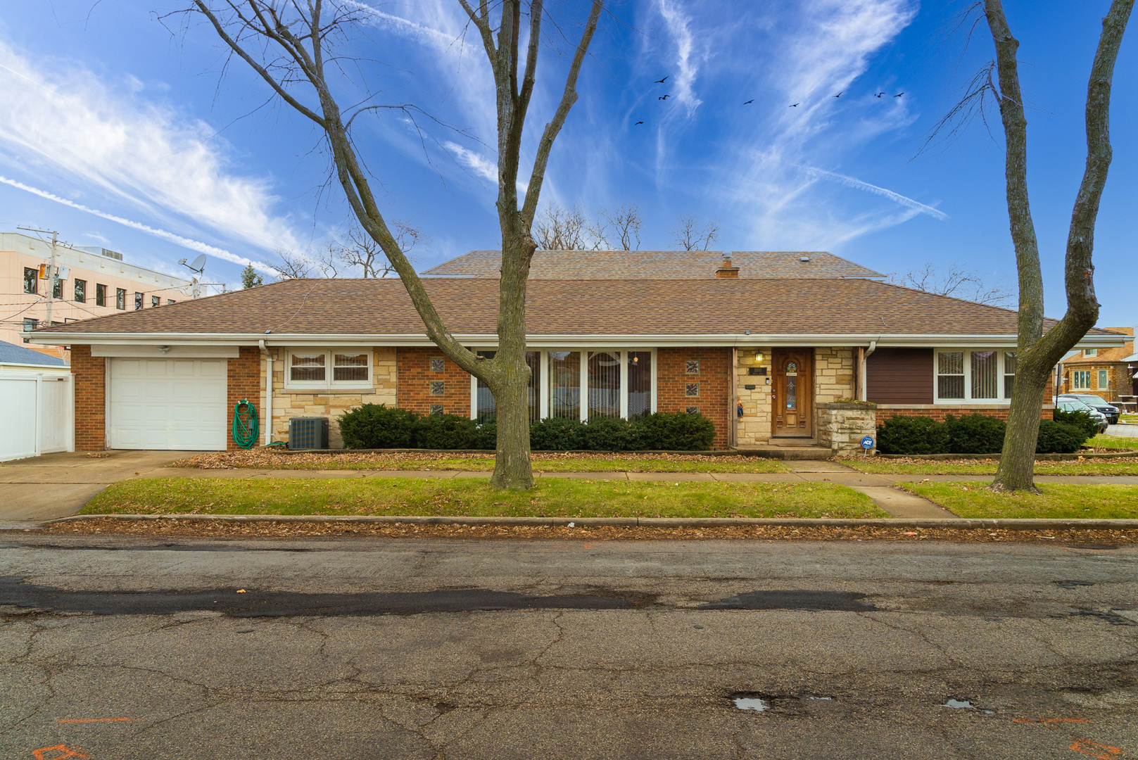 Undisclosed Address Chicago, IL 60634 - Photo 2 of 23 a front view of a house with a garden