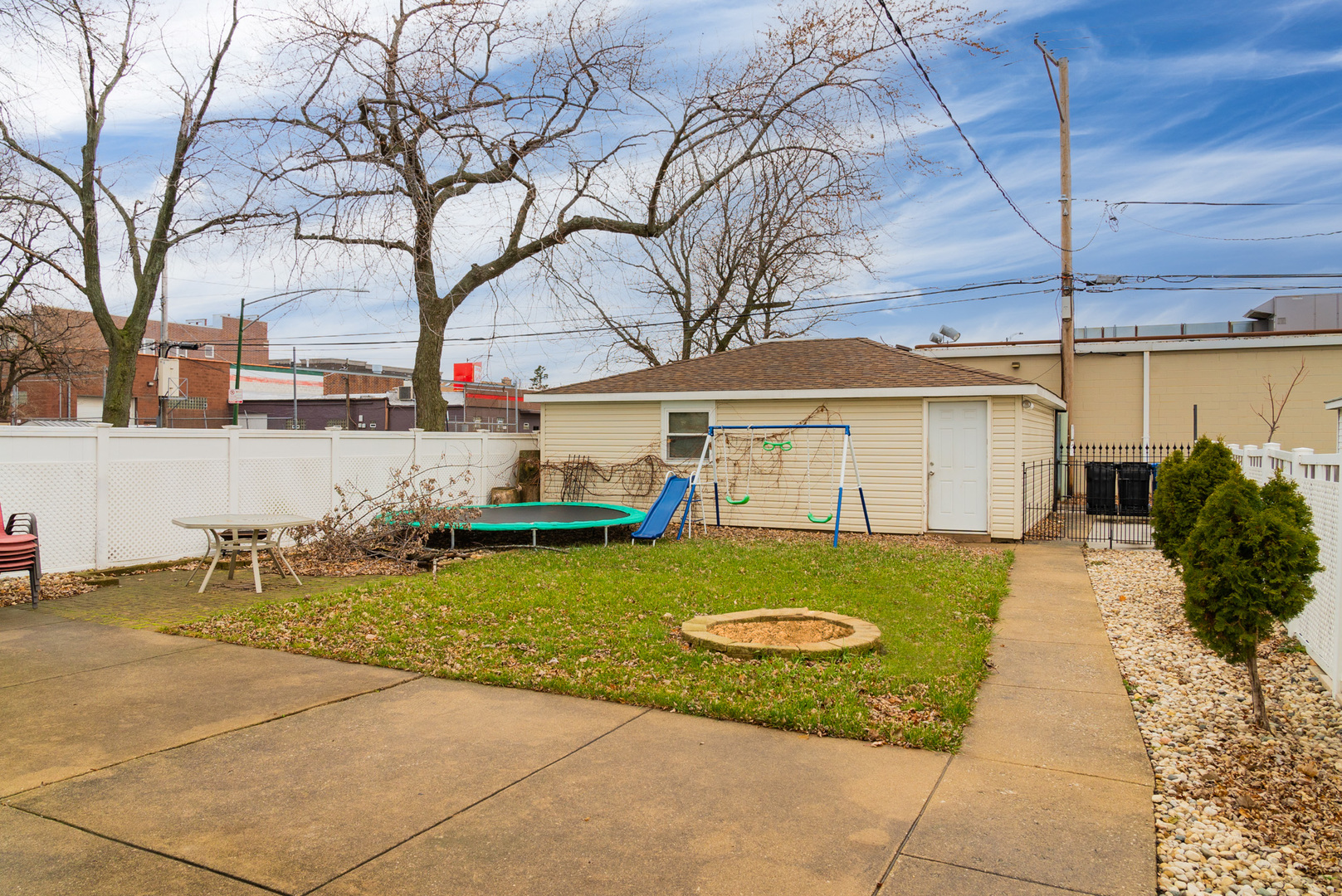 Undisclosed Address Chicago, IL 60634 - Photo 22 of 23 a view of a white house next to a yard with big trees
