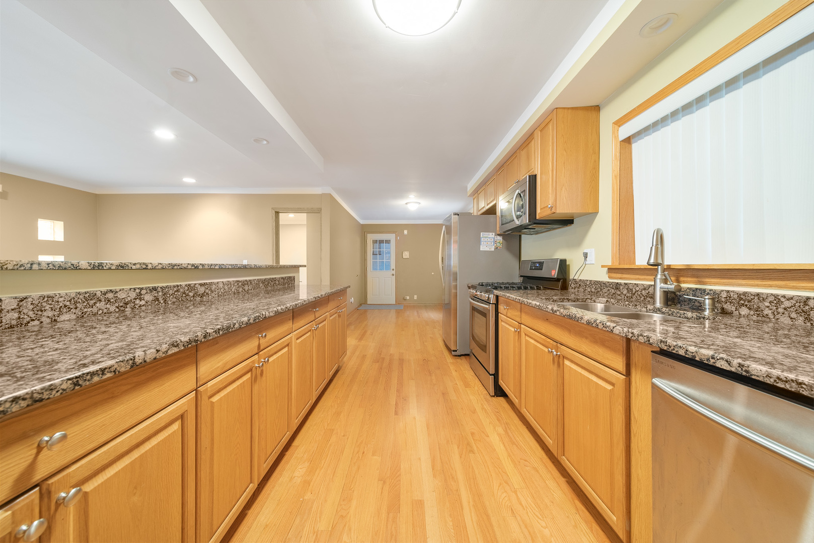 Undisclosed Address Chicago, IL 60634 - Photo 9 of 23 a large kitchen with stainless steel appliances granite countertop a sink and cabinets