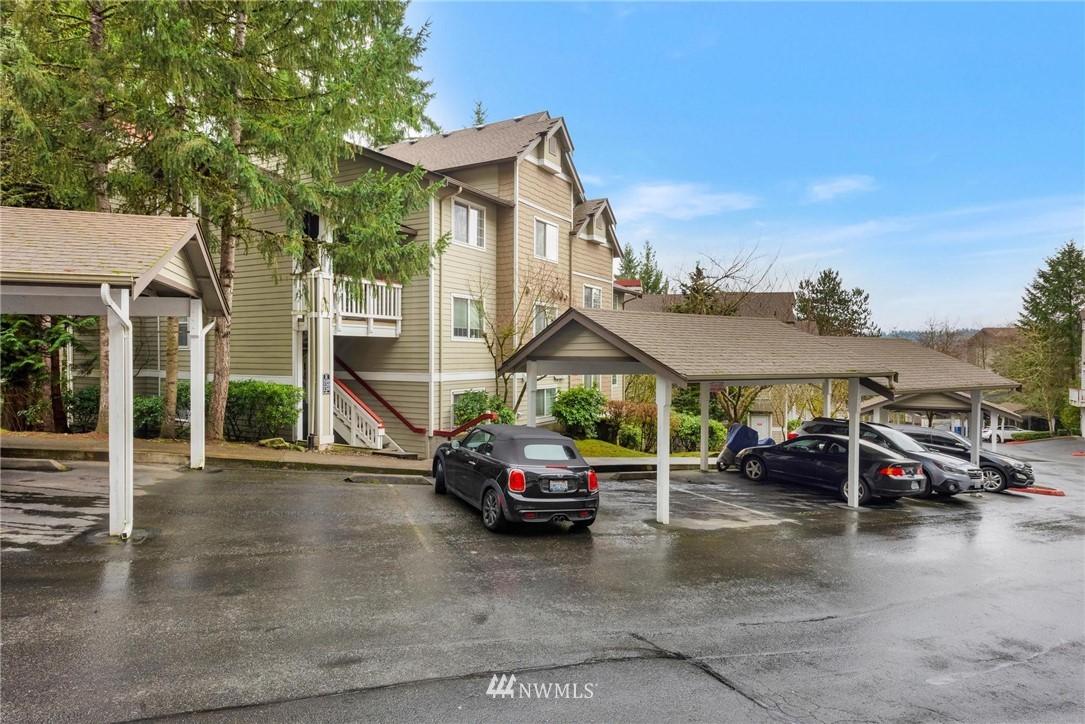 18505 Southeast Newport Way, Unit E320 Issaquah, WA 98027 - Photo 1 of 18 a car parked in front of a house