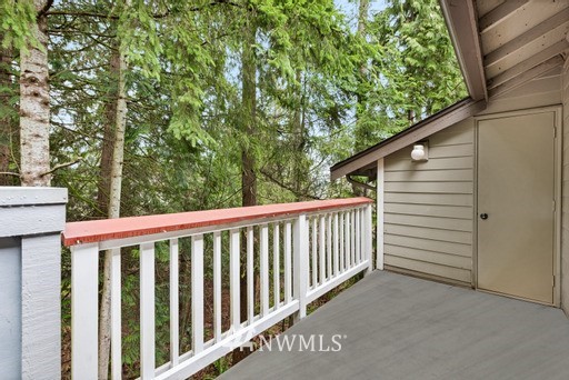 18505 Southeast Newport Way, Unit E320 Issaquah, WA 98027 - Photo 16 of 18 a view of a white house with a small yard and wooden fence