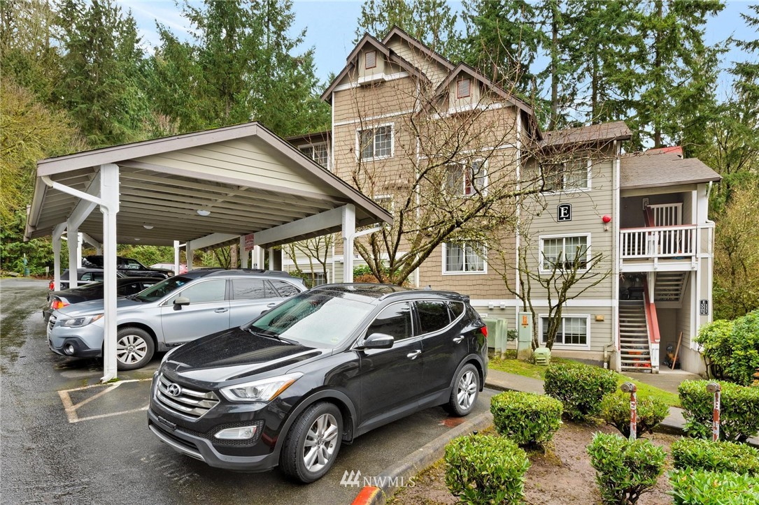 18505 Southeast Newport Way, Unit E320 Issaquah, WA 98027 - Photo 17 of 18 a car parked in front of white house