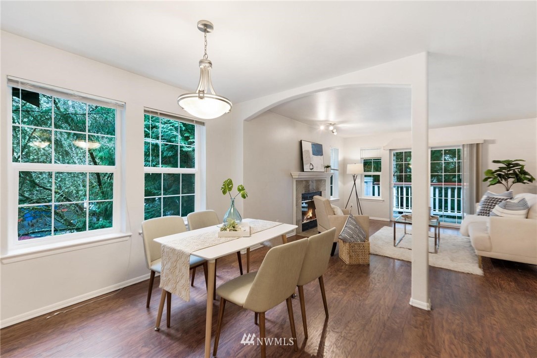 18505 Southeast Newport Way, Unit E320 Issaquah, WA 98027 - Photo 2 of 18 a view of a dining room with furniture window and wooden floor