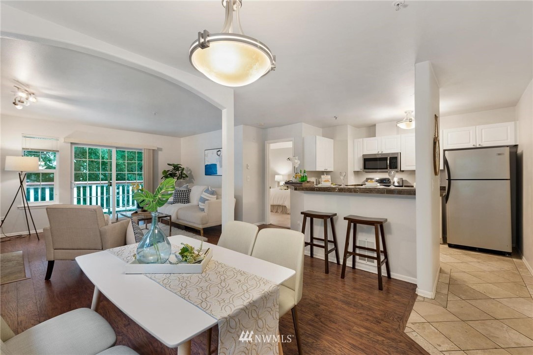 18505 Southeast Newport Way, Unit E320 Issaquah, WA 98027 - Photo 3 of 18 a view of kitchen with refrigerator and wooden floor