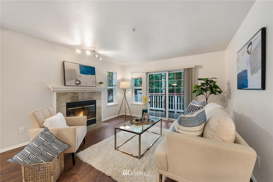 18505 Southeast Newport Way, Unit E320 Issaquah, WA 98027 - Photo 5 of 18 a living room with furniture and a fireplace