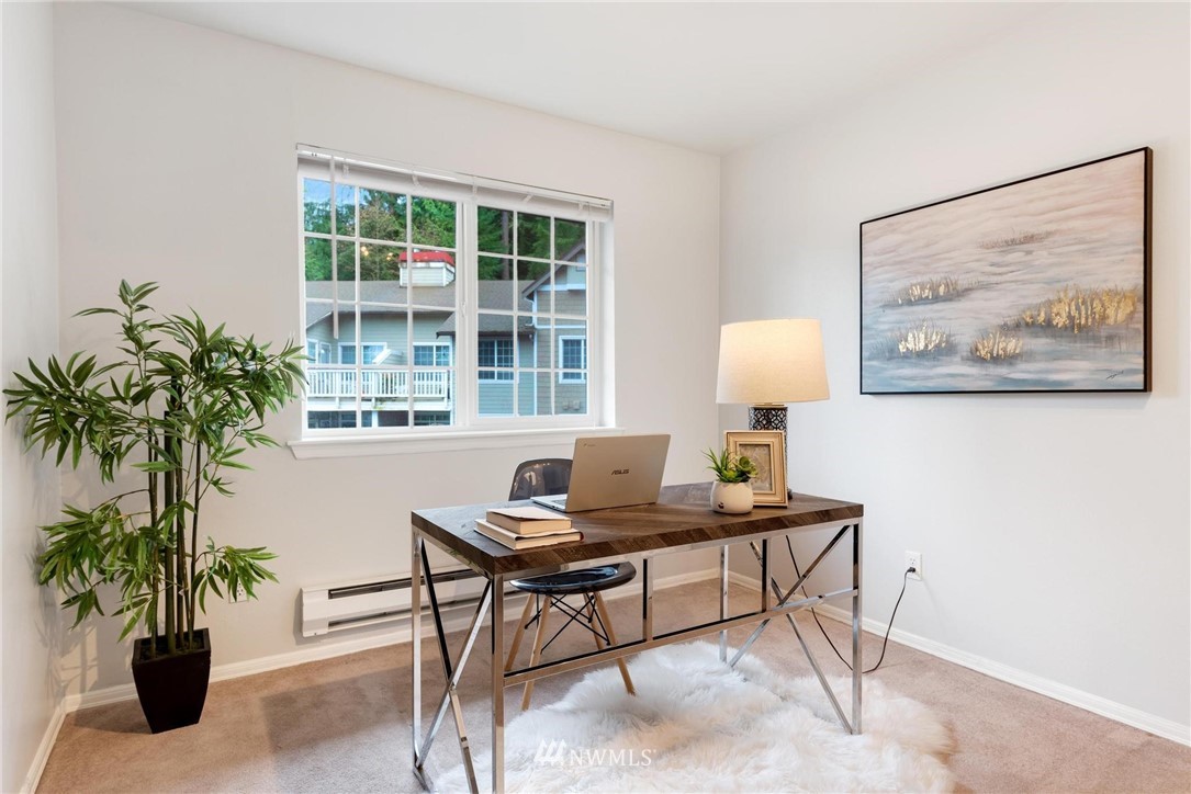 18505 Southeast Newport Way, Unit E320 Issaquah, WA 98027 - Photo 10 of 18 a workspace with furniture and a potted plant