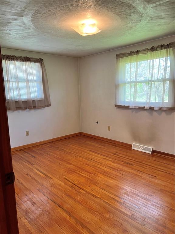 880 Pizza Barn Road Blairsville, PA 15717 - Photo 36 of 44 an empty room with wooden floor and windows