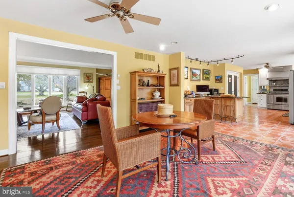 a living room with furniture a rug and a flat screen tv