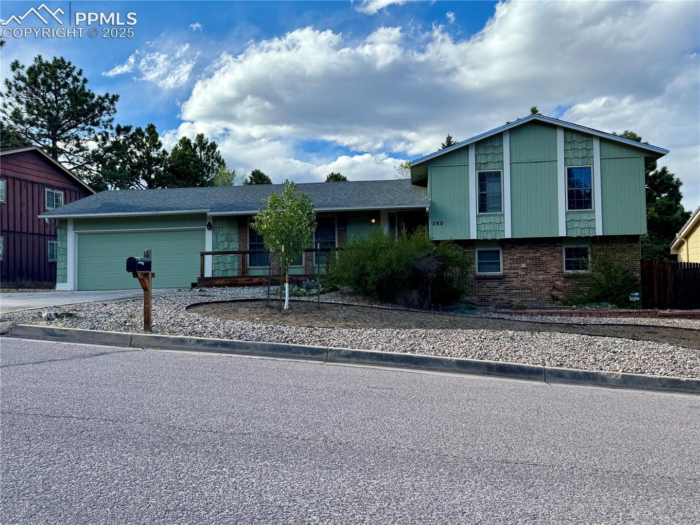 280 Raven Hills Road Colorado Springs, CO 80919 - Photo 1 of 48 Tri-level home with brick siding, driveway, and a garage