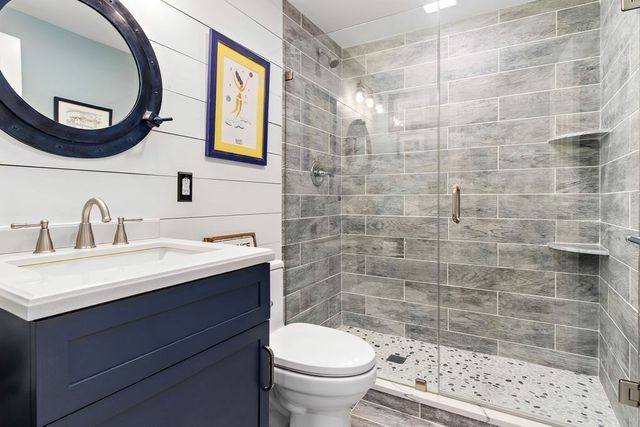 a bathroom with a sink a toilet and a mirror