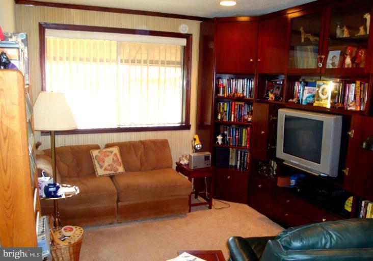 18709 Walkers Choice Road, Unit 6 Gaithersburg, MD 20886 - Photo 1 of 10 a living room with furniture and a flat screen tv