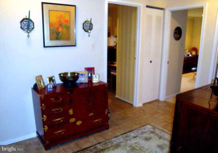 18709 Walkers Choice Road, Unit 6 Gaithersburg, MD 20886 - Photo 3 of 10 a view of a hallway with wooden floor and closet