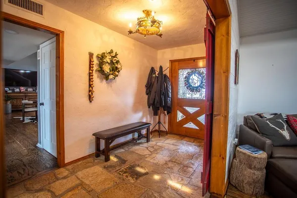 a living room with furniture and a painting on the wall