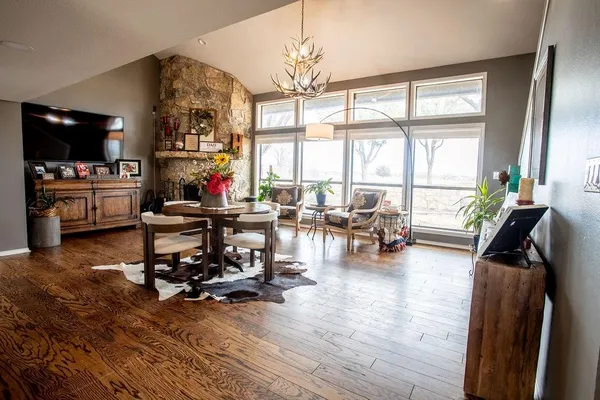 a living room filled with furniture and floor to ceiling window