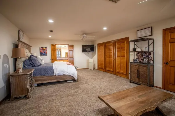 a spacious bedroom with a bed and furniture