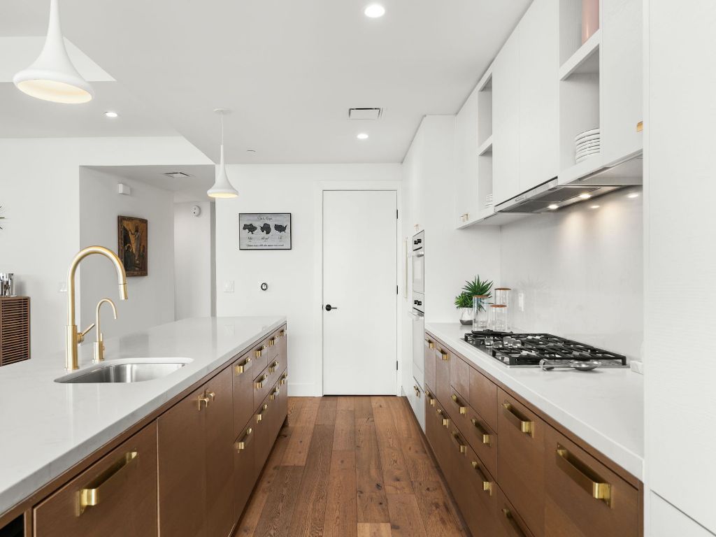 70 Rainey Street, Unit 2301 Austin, TX 78701 - Photo 11 of 40 a kitchen with stainless steel appliances granite countertop a sink stove and refrigerator
